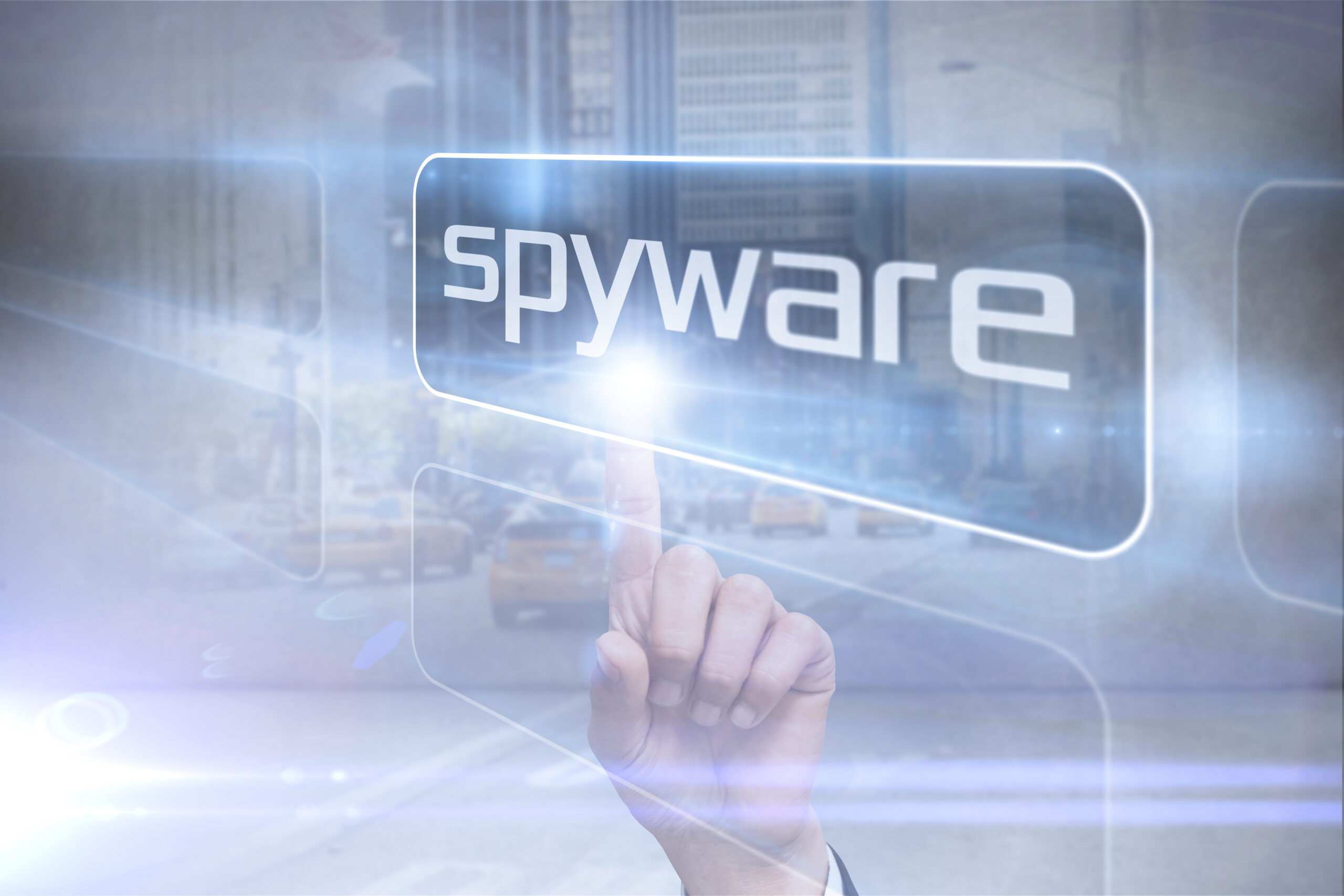 Businessman pointing to word spyware against urban projection on wall